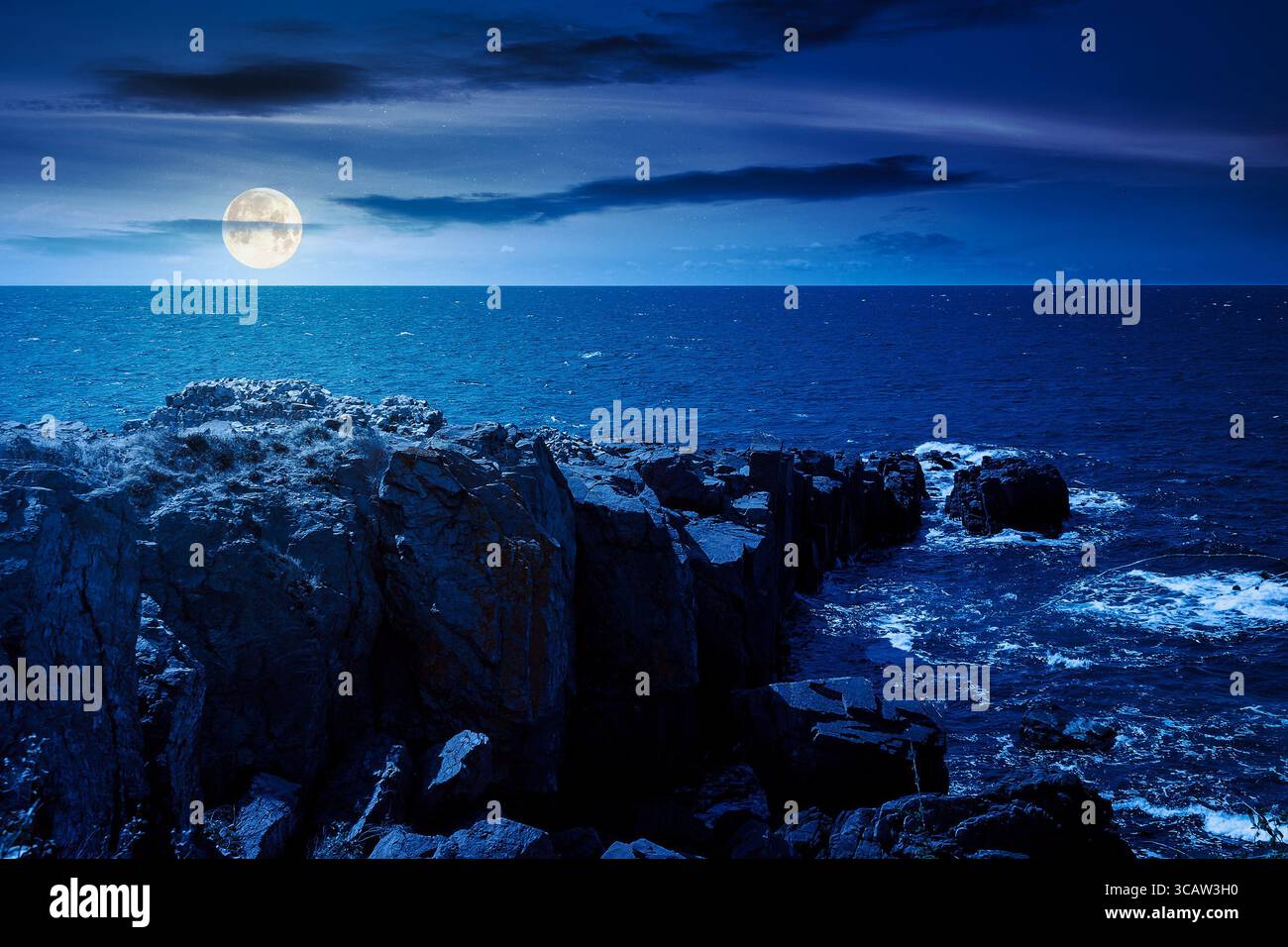 landscape with sea and coast with rock at night. vacation season with beautiful seascape in summer. travel background with water splash on stone in fu Stock Photo