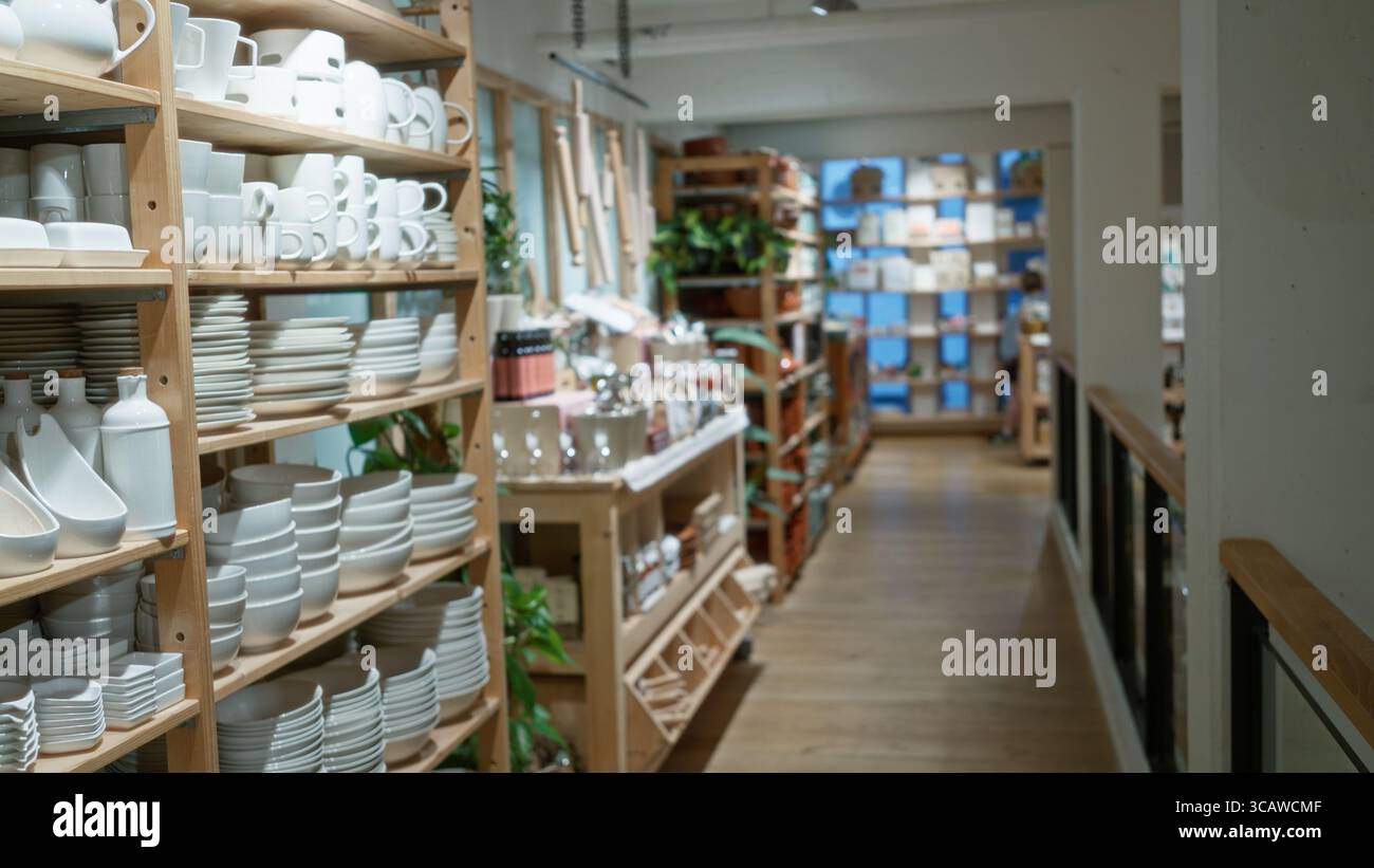 Blurred shop interior with shelves of porcelain dishes and decor ...