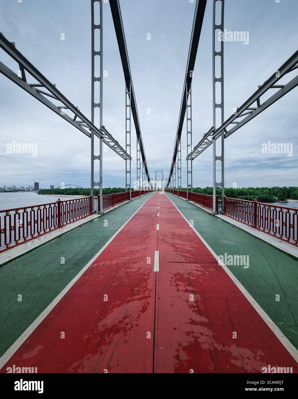 Empty pedestrian bridge over the river. Symmetric diminishing ...