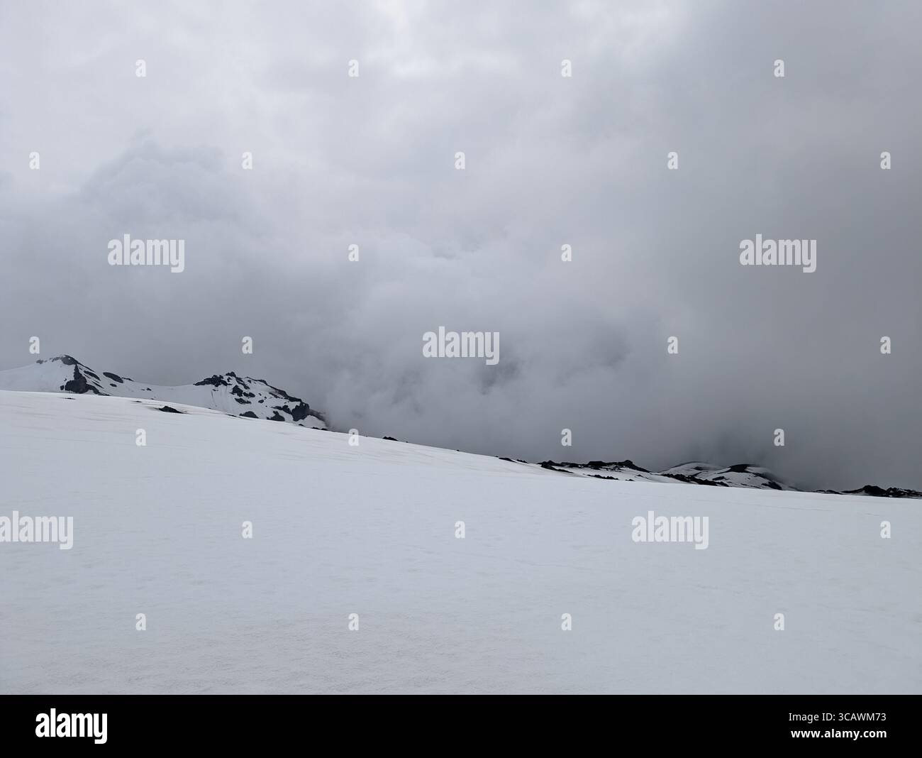 Snow-Covered Volcanic Ridge in Dense Cloud – Icelandic Highlands - Smartphone Captured Stock Image