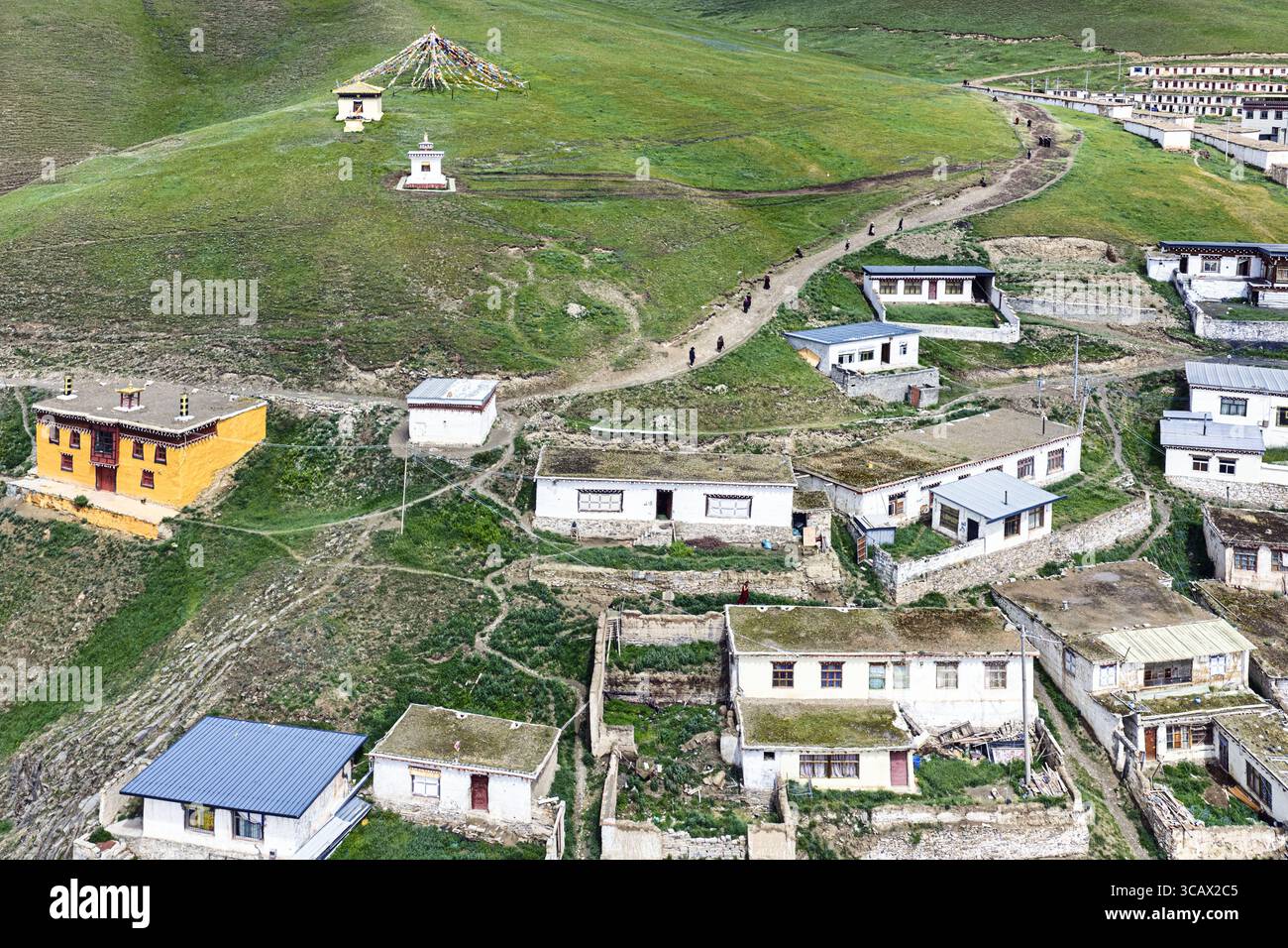 Aerial view of the scattered buildings nestled into the vibrant green ...