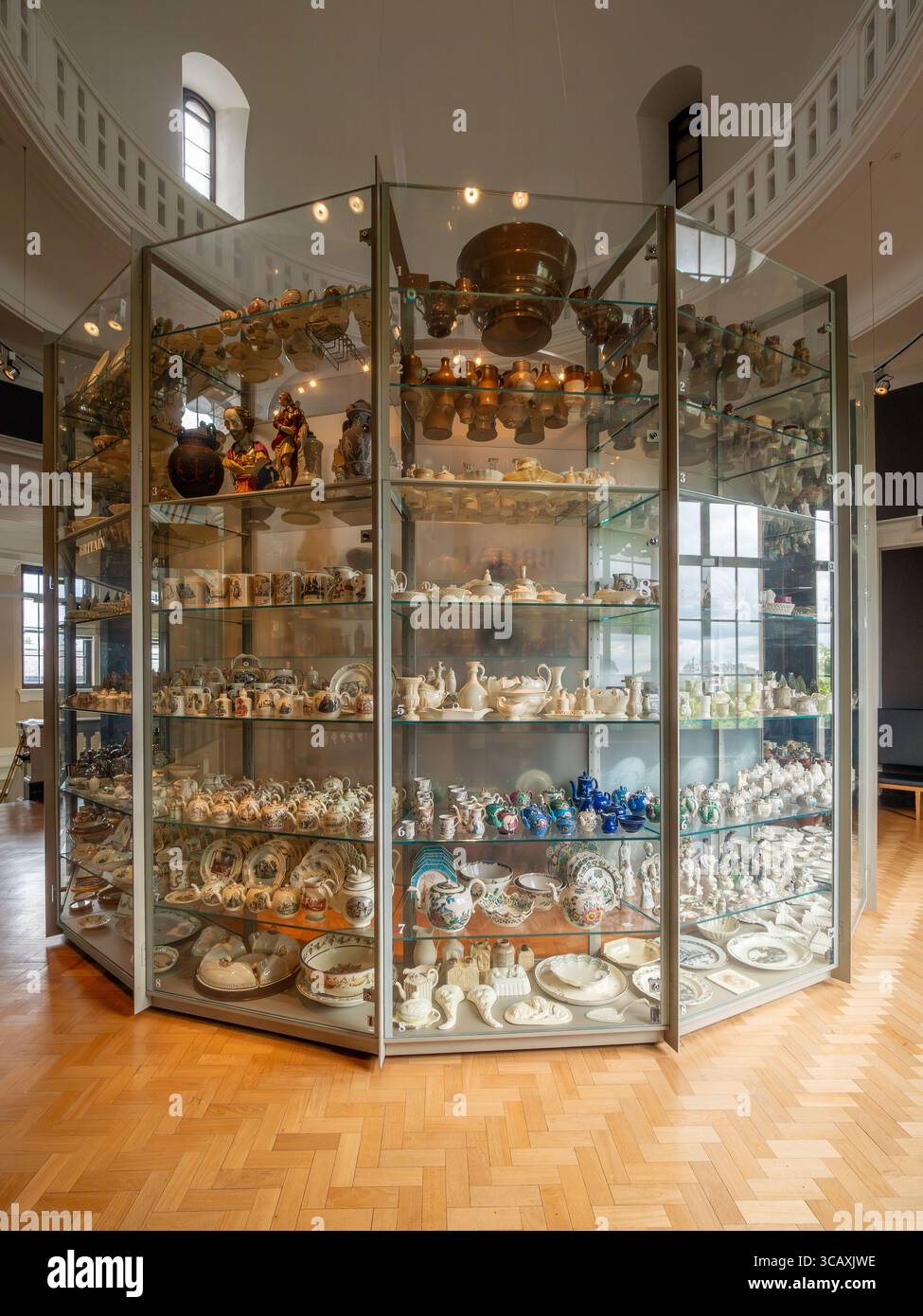 A large display case filled with a vast collection of British ceramics and pottery at the Victoria and Albert Museum (V&A) in London, UK. Stock Photo