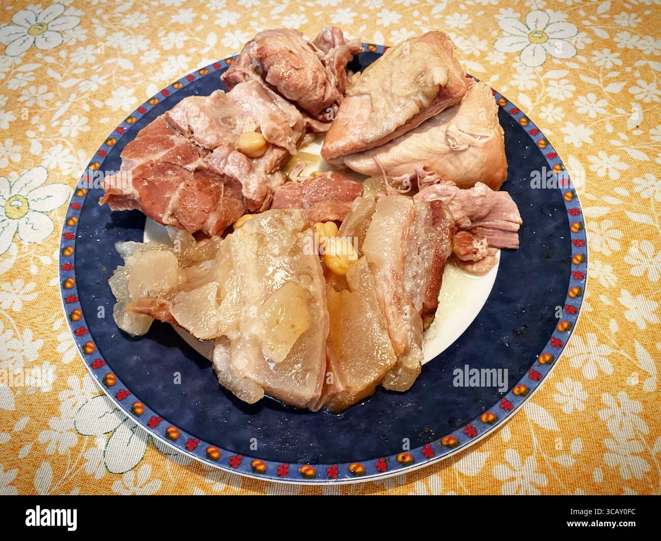 Bacon and Iberian pig meat stewed in a home in Prado del Rey, Cádiz, Andalusia, Spain - Smartphone Captured Stock Image