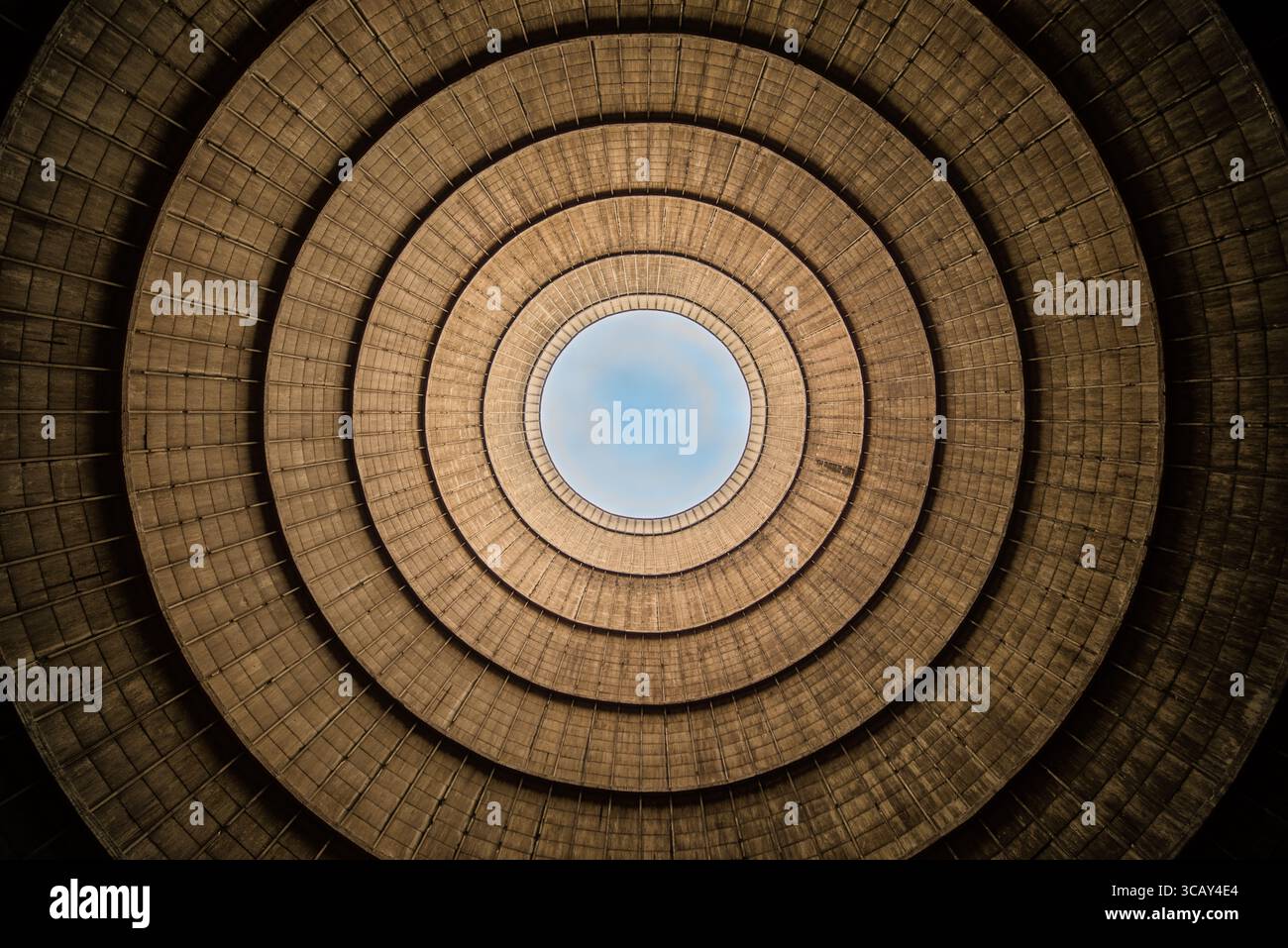 Inside view of an abandoned industrial cooling tower with concentric ...