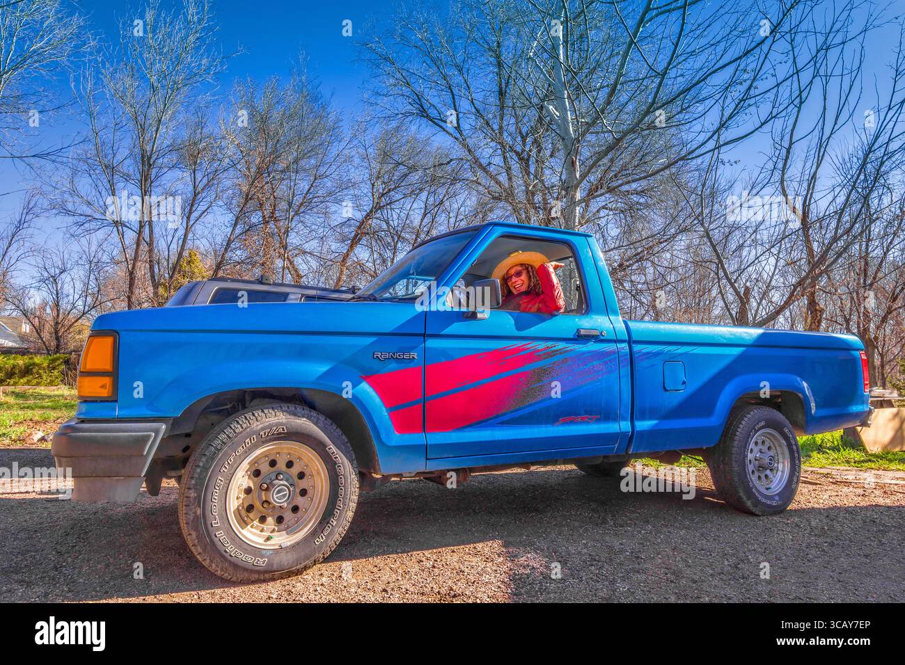 Smiling lady in early 2000s Ford Ranger Sport pick-up truck - Lakewood, Colorado, USA. Stock Photo