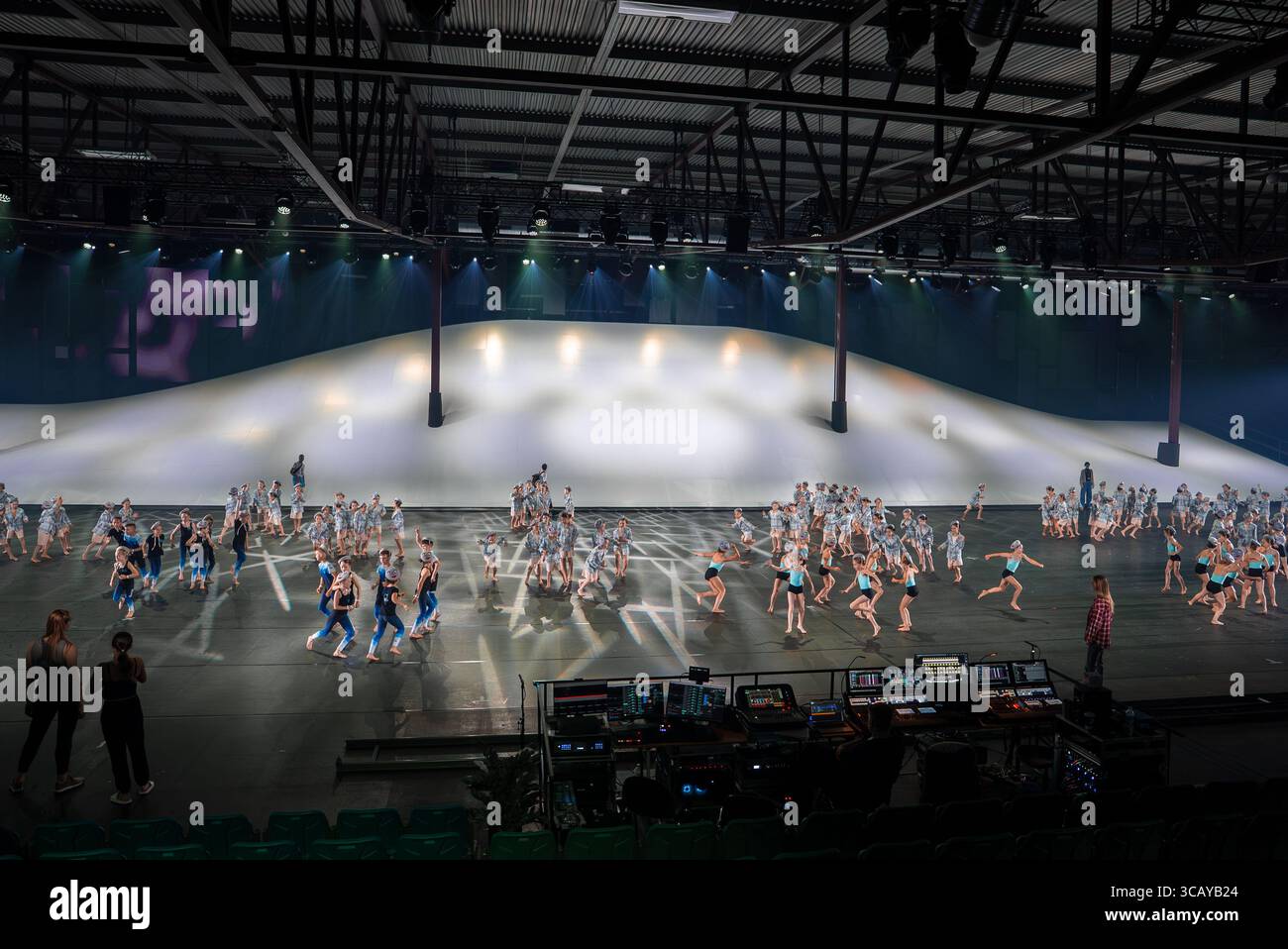 Young Dancers Performing on a Modern Indoor Stage with Lighting Rigs Stock Photo
