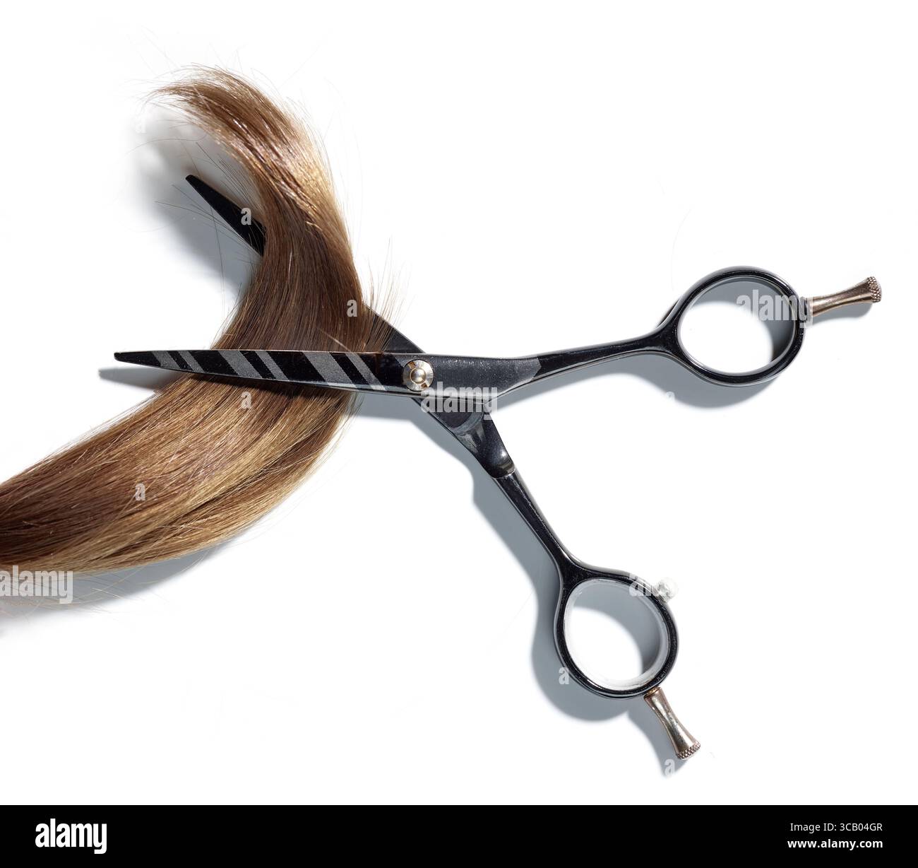 brown hair lock and scissors isolated on white background, top view Stock Photo