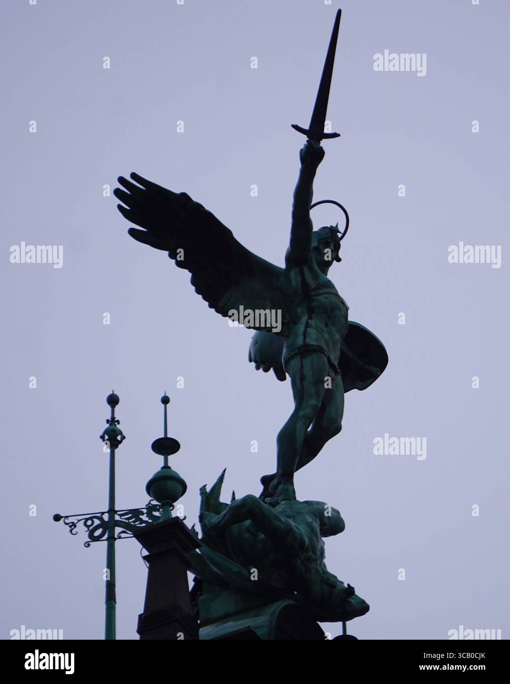 Vertical close up of a St. Michael statue with a sword on the landmark ...
