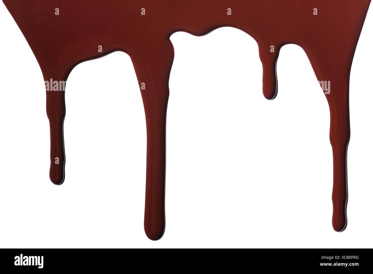 Melted chocolate dripping isolated on white background. Stock Photo
