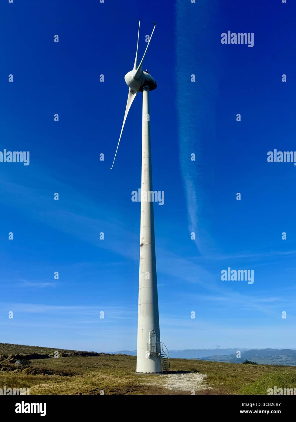 Wind turbines generating clean and renewable energy in the Azores, Portugal, under a clear blue sky. - Smartphone Captured Stock Image