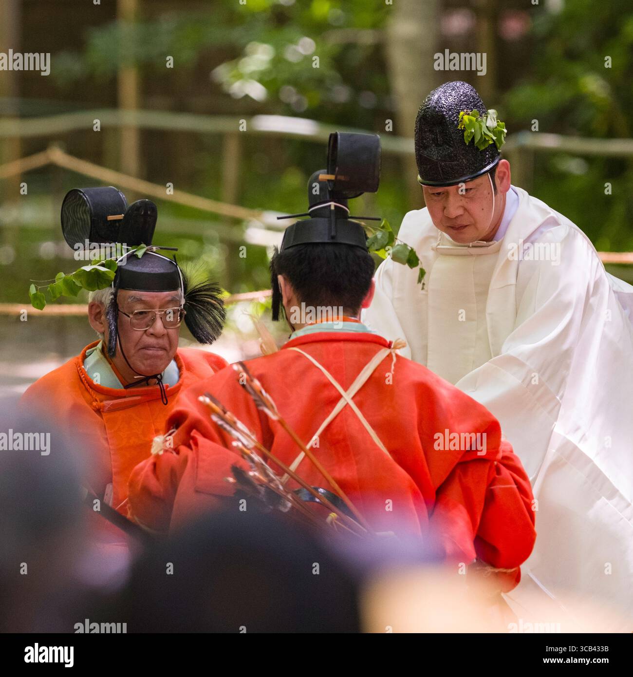 Japanese priests dressed in traditional robes participate in an outdoor ...