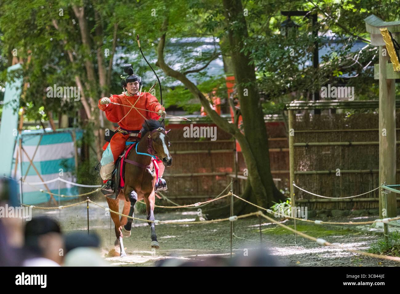 A traditional Japanese yabusame archer in vibrant attire skillfully ...
