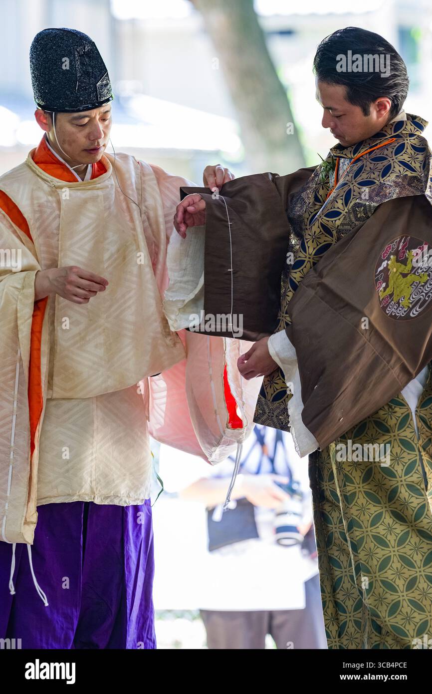 Two men wearing traditional Japanese robes before the start of the Kamo ...