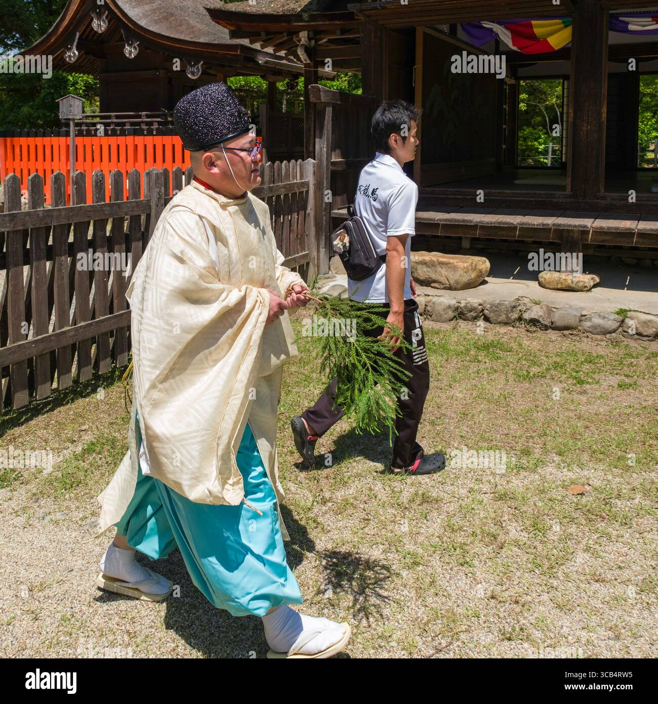 A Japanese Shinto priest wearing traditional clothing participates in ...