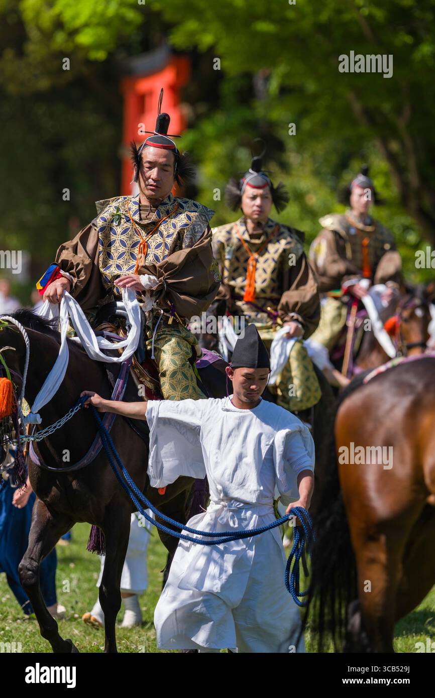 Men dressed in traditional Japanese attire in procession of riders on ...