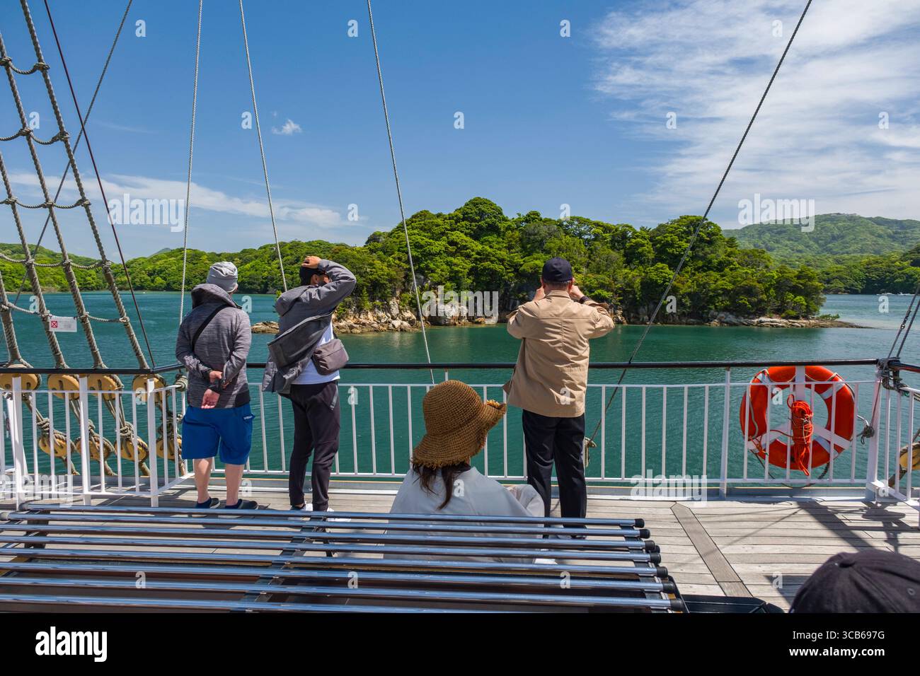 Group of tourists on a ship deck of the Pearl Queen cruise ship ...