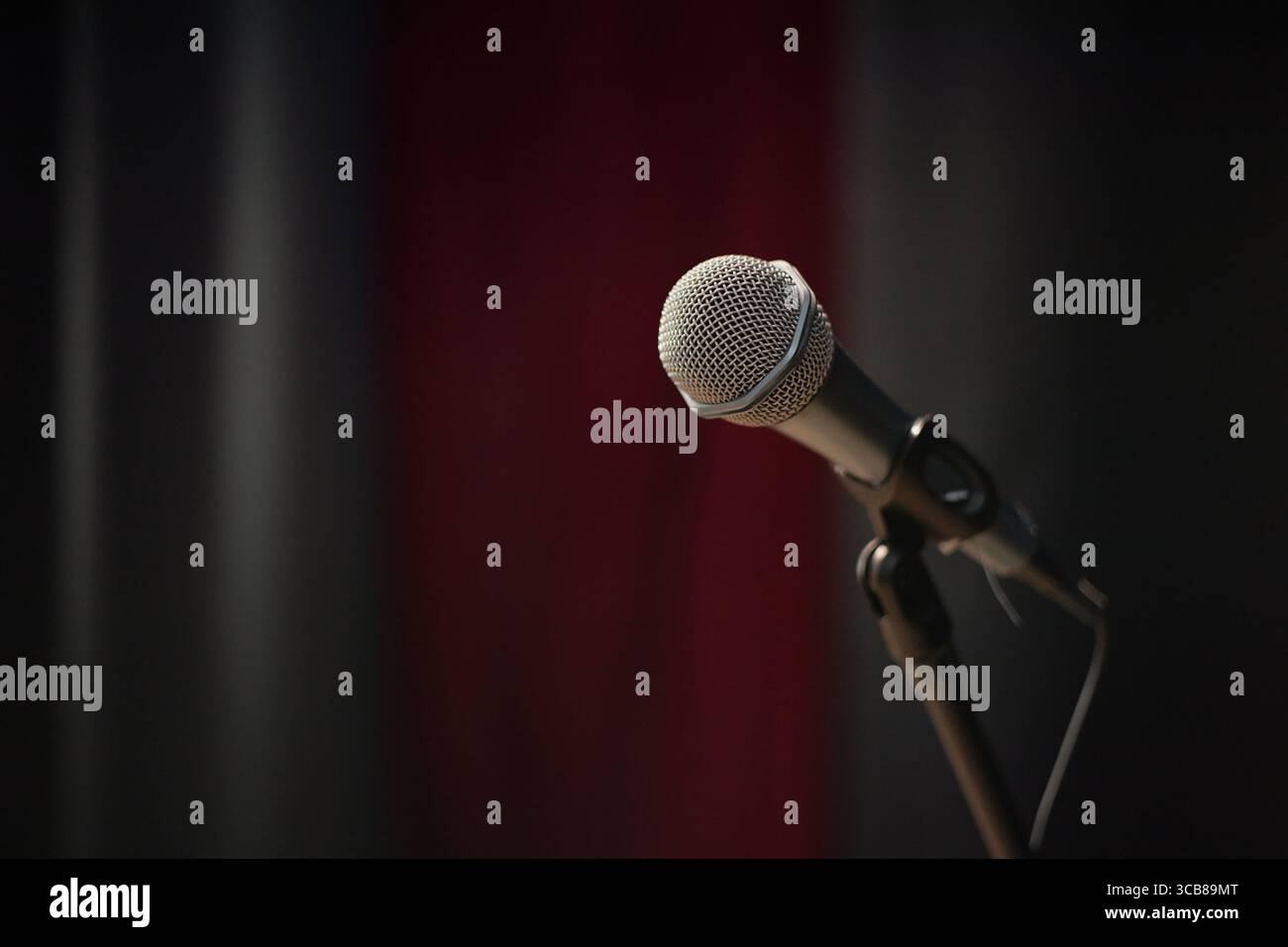 Closeup of Microphone Standing on Stage Awaiting Performance at Talent Competition Stock Photo