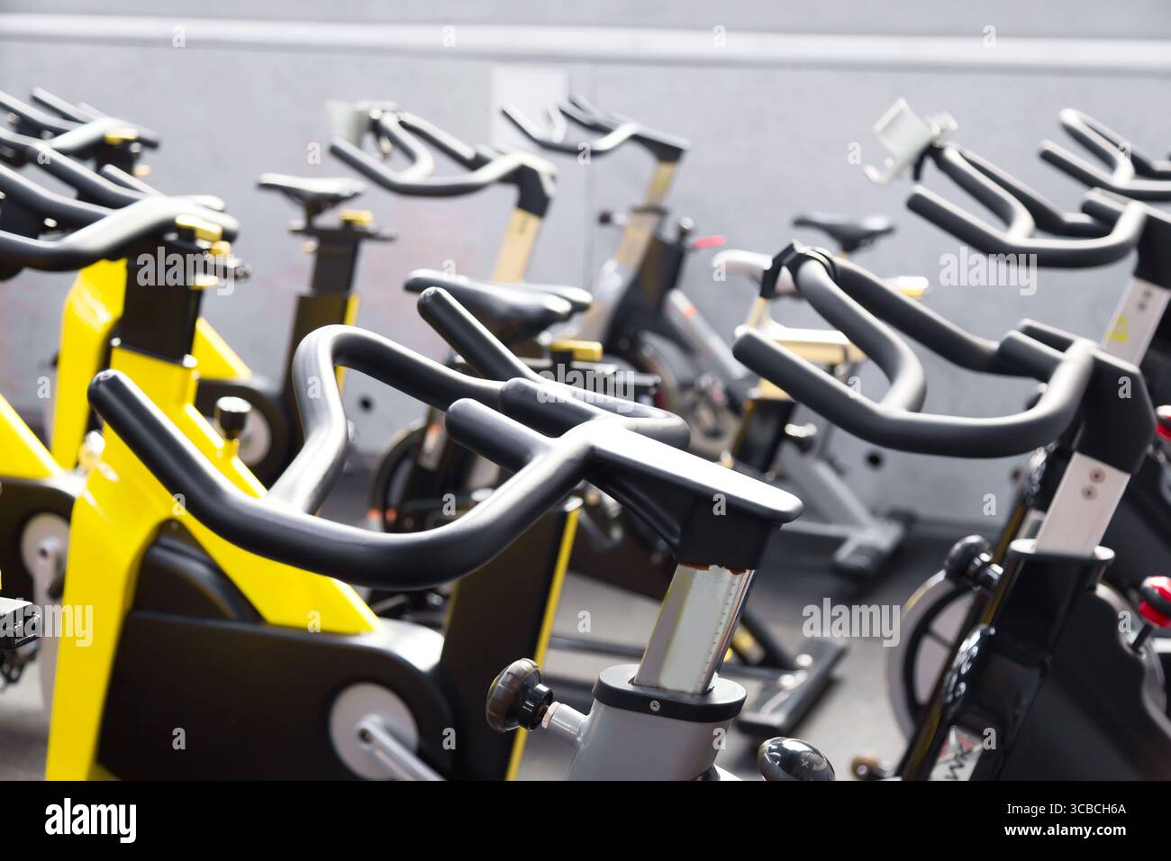 Modern fitness gym. Sports gym or fitness bike equipment. Stock Photo