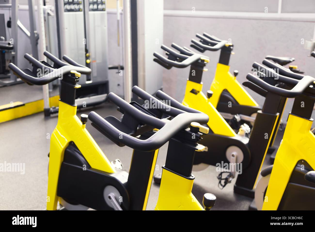 Modern fitness gym. Sports gym or fitness bike equipment. Stock Photo