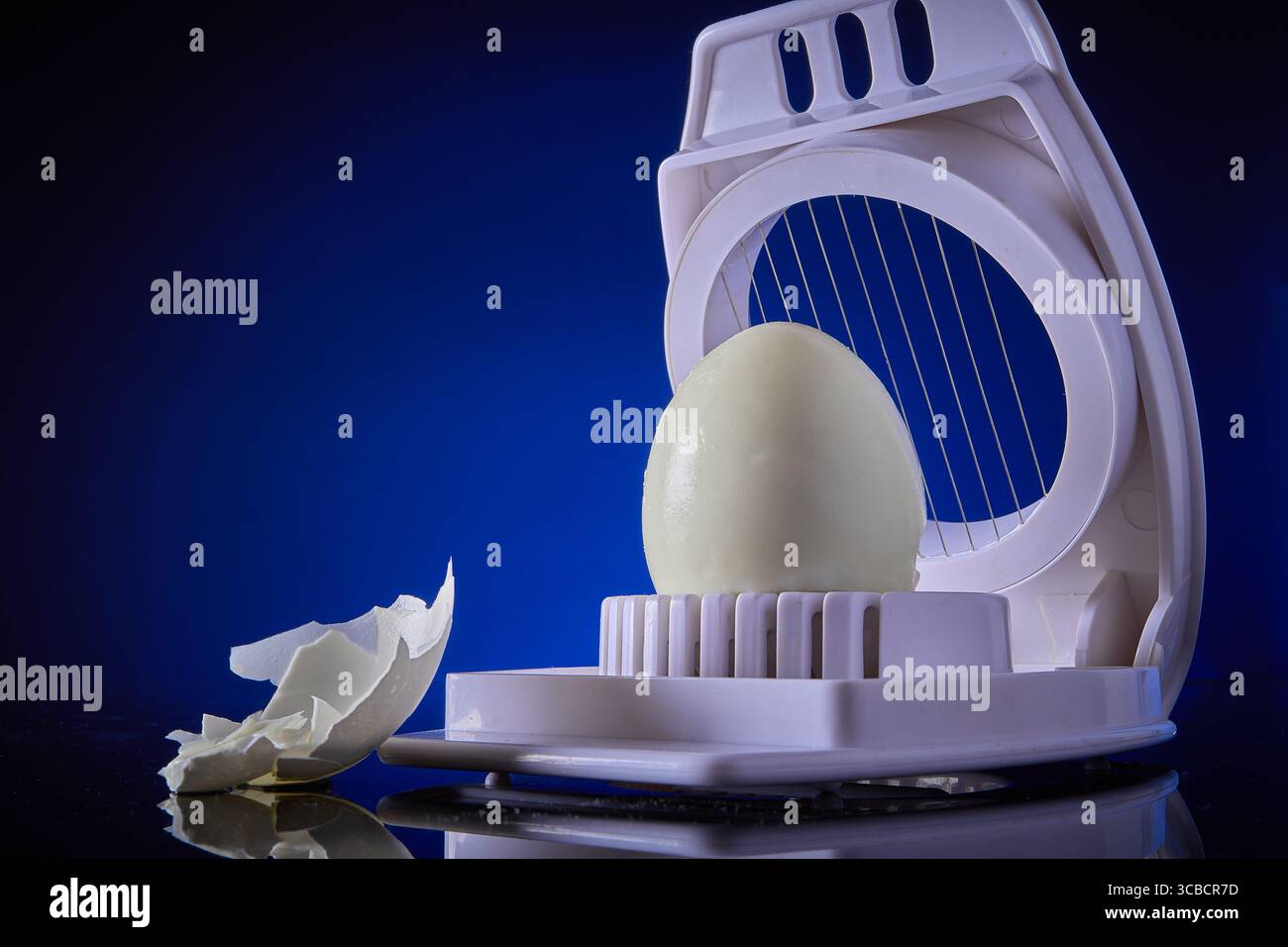 Boiled egg and egg slicer Stock Photo