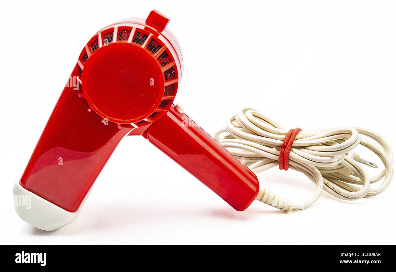 Vintage red plastic hair dryer isolated on white background Stock Photo