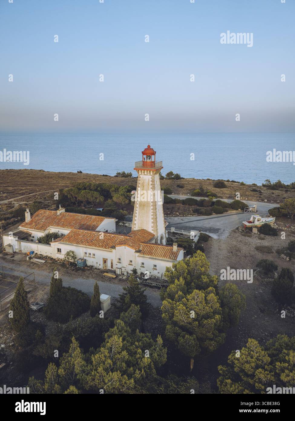 Aerial view of a striking white lighthouse with a red top standing ...