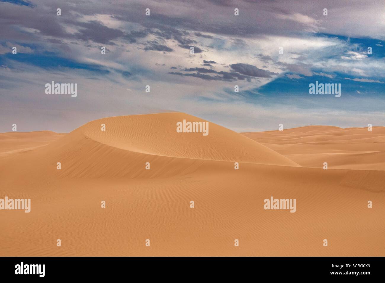 Golden Sand Dune Under Dramatic Desert Sky Stock Photo - Alamy