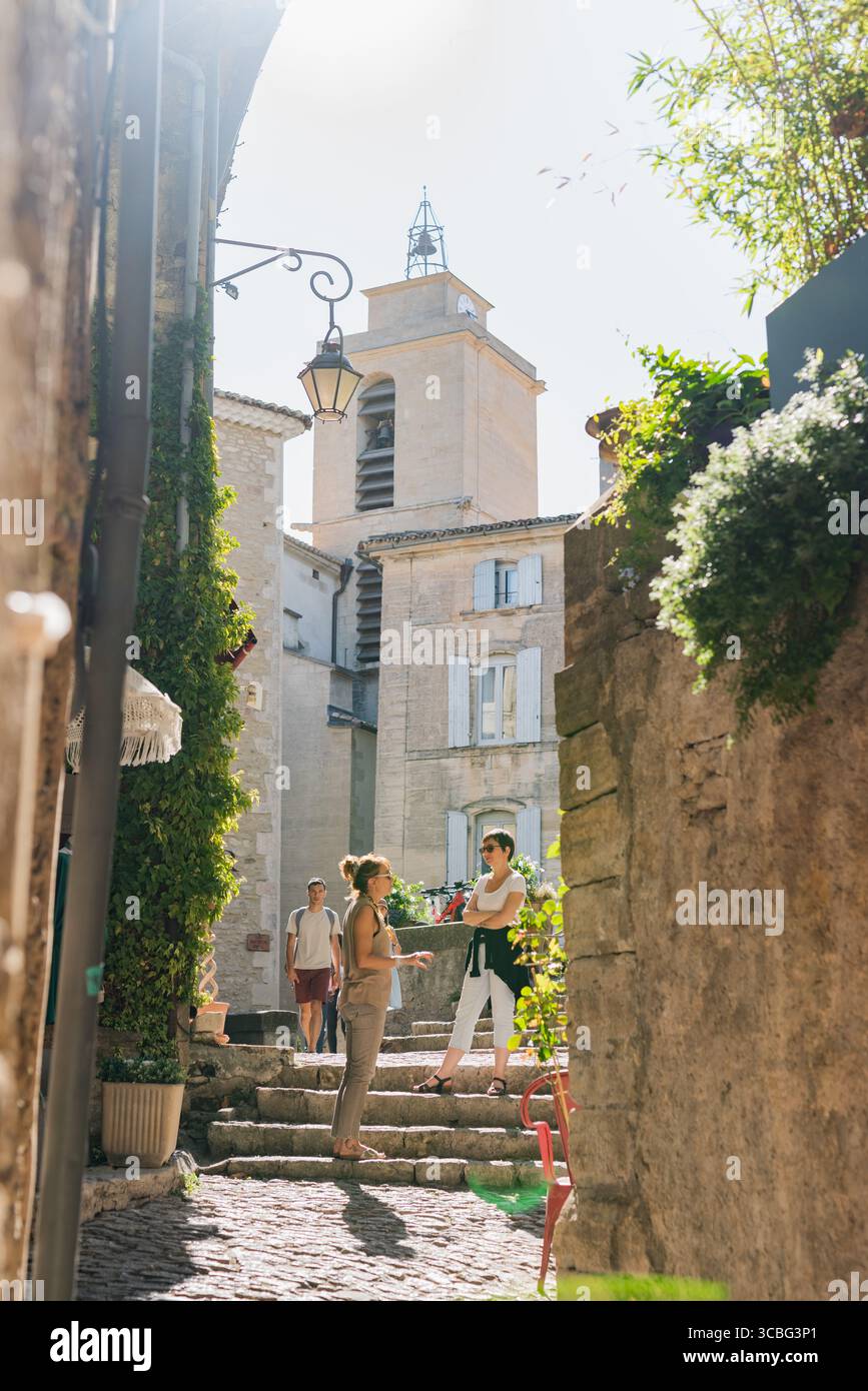 Busy with cafes and boutiques, the delightful Place Genty Pantaly is a medieval square in the heart of Gordes, Vaucluse, France Stock Photo