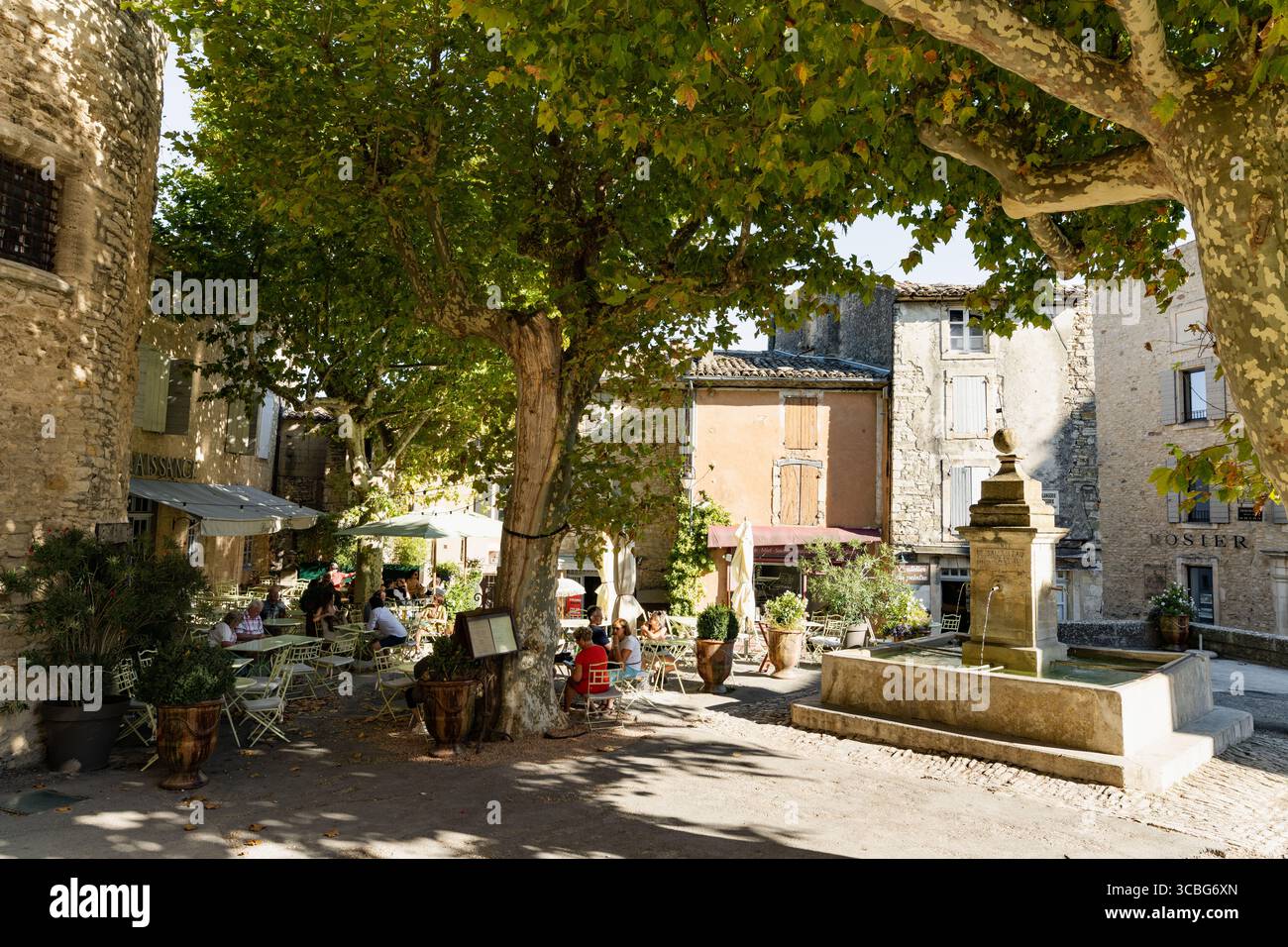 Busy with cafes and boutiques, the delightful Place Genty Pantaly is a medieval square in the heart of Gordes, Vaucluse, France Stock Photo