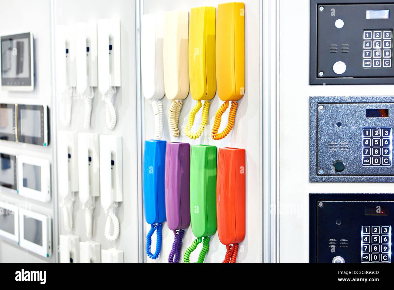 Colored handsets, control panels and intercom monitors on display in a store Stock Photo