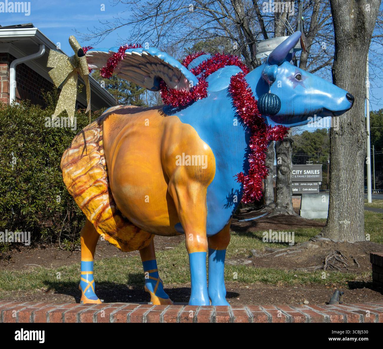 Whimsical and surreal, the winged cow statue in Durham, North Carolina, blends barnyard charm with a touch of fantasy. Stock Photo