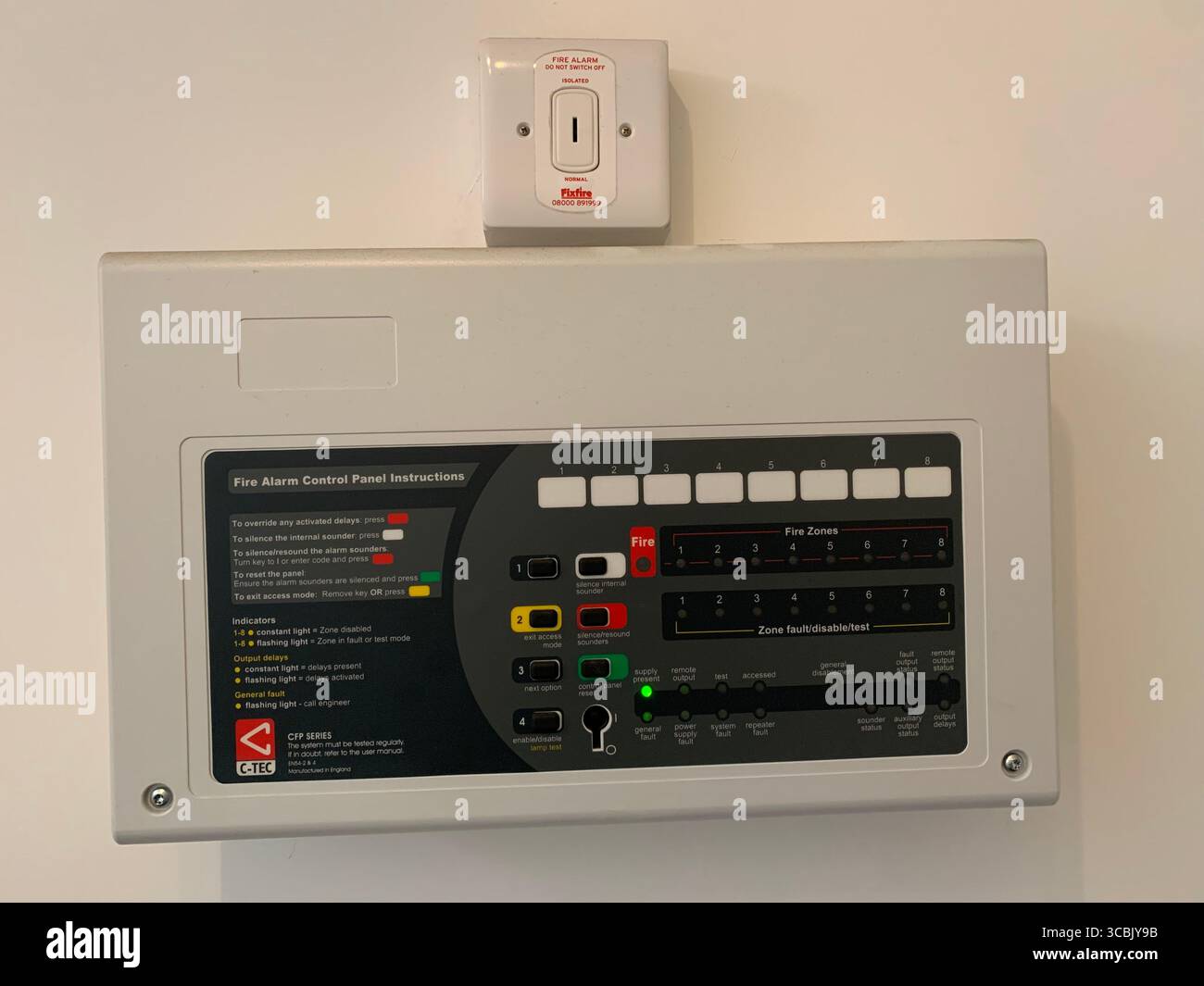 Fire alarm house home unit fitted test button sounder style type flats flat home British system English fitted on the wall residence safety fire English - Smartphone Captured Stock Image