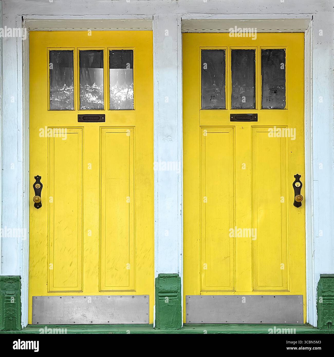 Vibrant yellow Chicago twin entrances with vintage handles, rectangular glass panels. - Smartphone Captured Stock Image