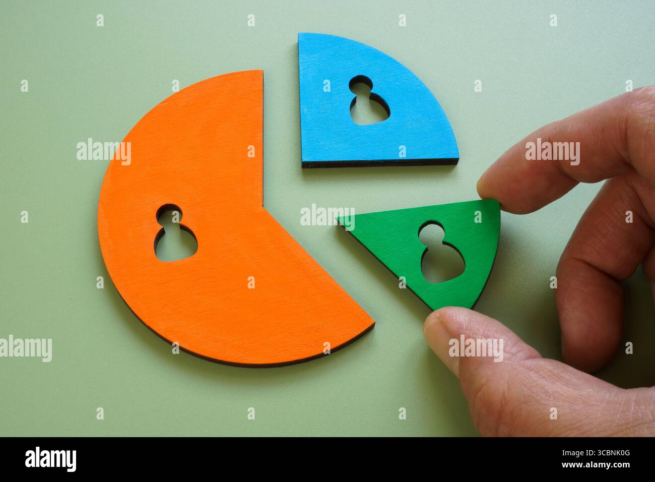 Hand holding a customer chart segment. Market share and client analysis. Stock Photo
