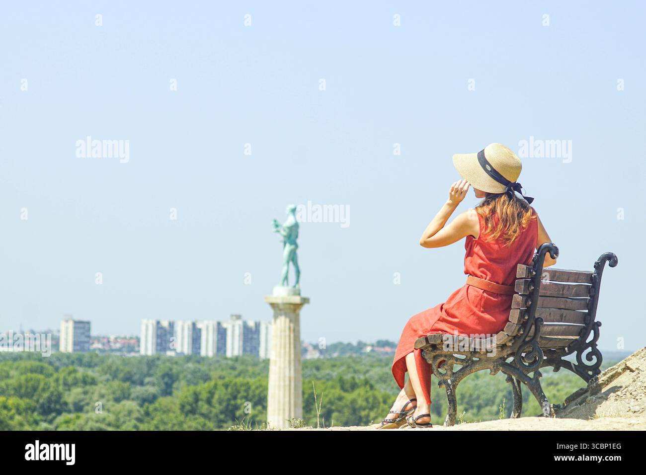 A female visitor admires the view from the Belgrade Fortress. Concept of landmark tourism, blending cultural heritage with personal travel experiences Stock Photo