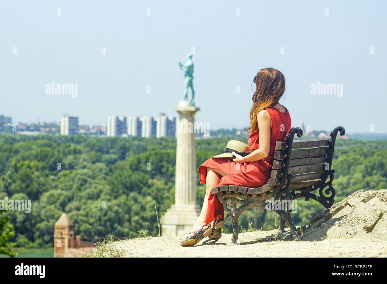 Serene travel moments: woman on a solo tour of Belgrade Fortress on a summer day. Timeless journeys, cultural appreciation, slow-paced exploration Stock Photo