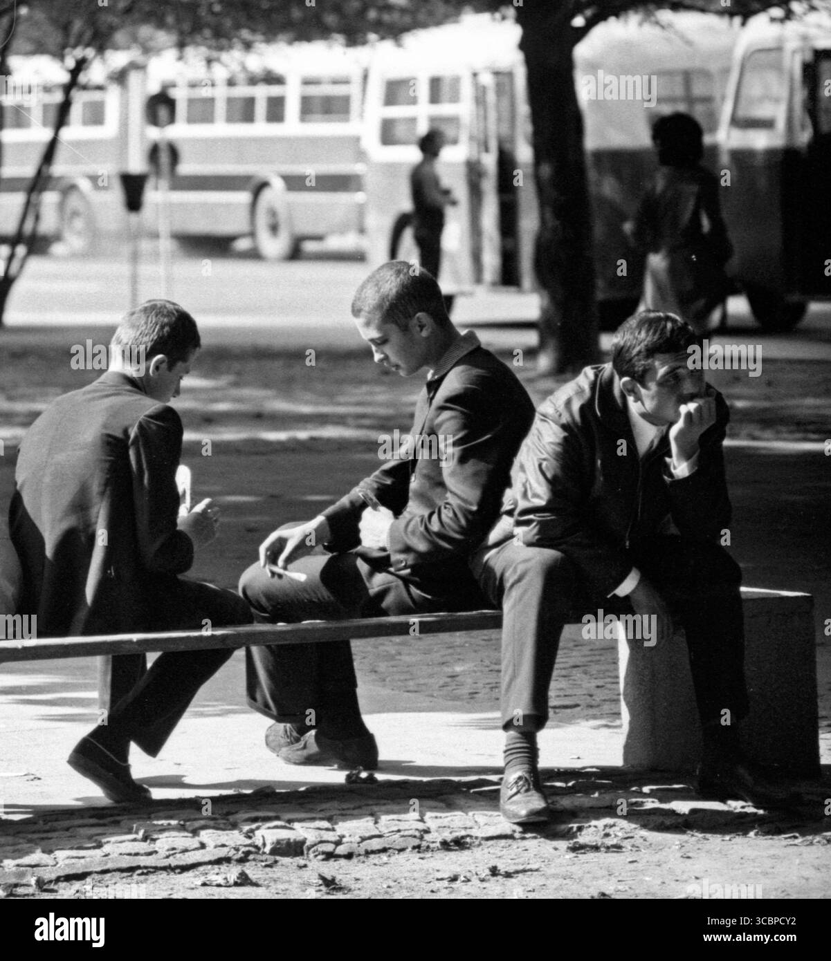 Two boys are playing cards on a bench Stock Photo - Alamy