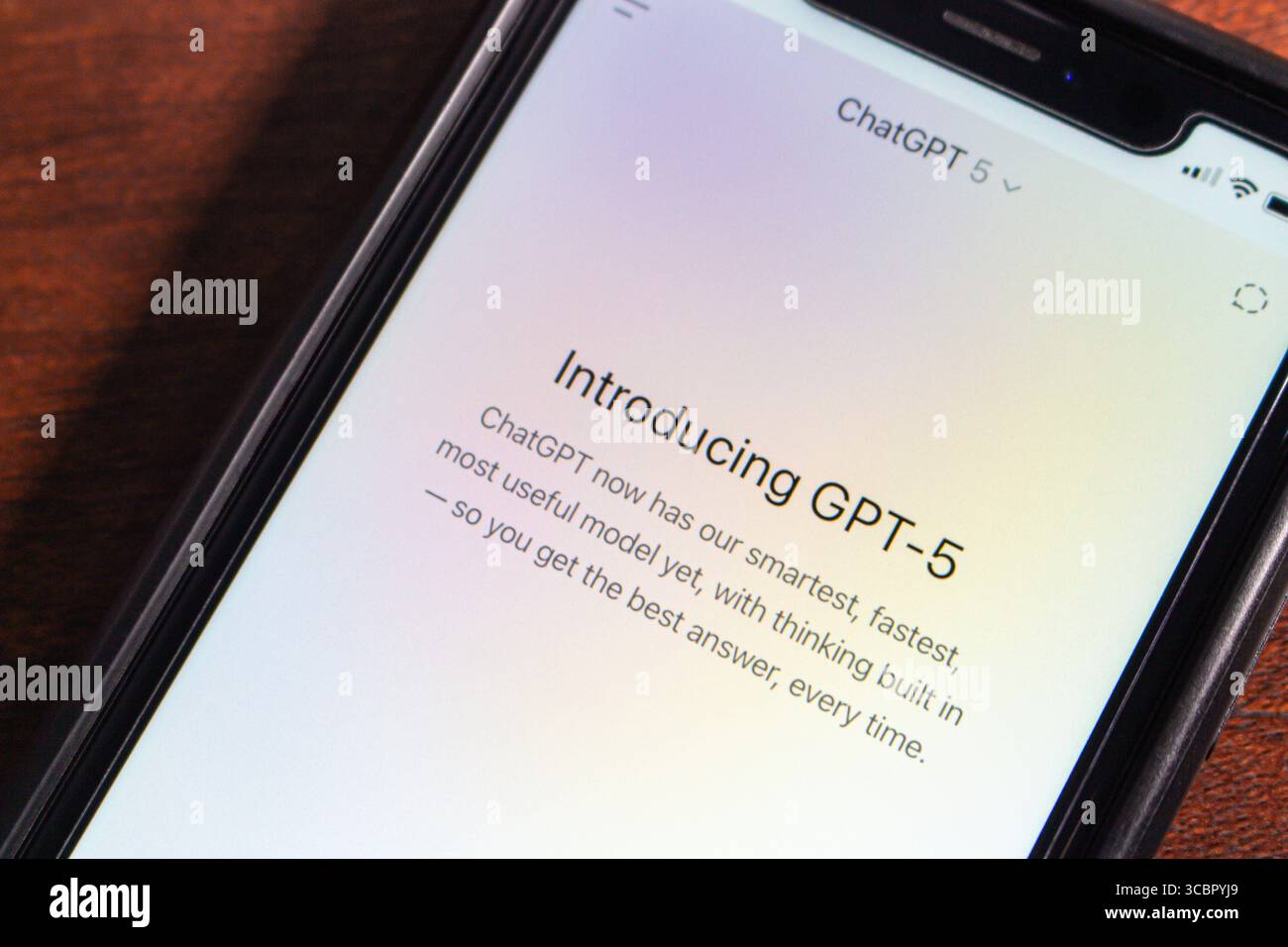 Close-up of a smartphone screen showing the GPT-5 introduction message in the ChatGPT app, highlighting its advanced AI capabilities. Stock Photo