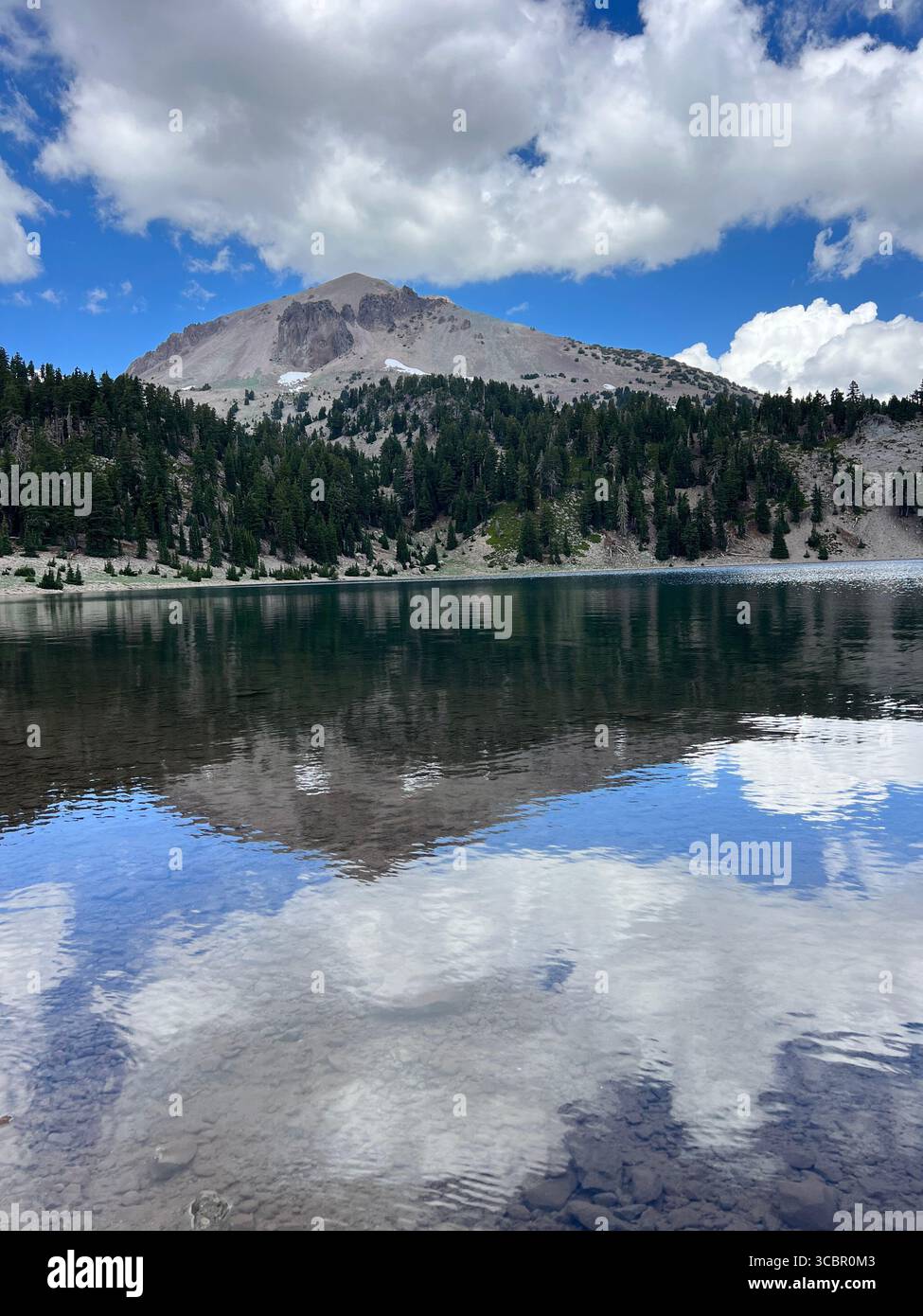 Helen Lake vertical view with Lassen Peak reflection, portrait orientation showcasing pristine alpine conditions, Lassen Volcanic National Park. - Smartphone Captured Stock Image