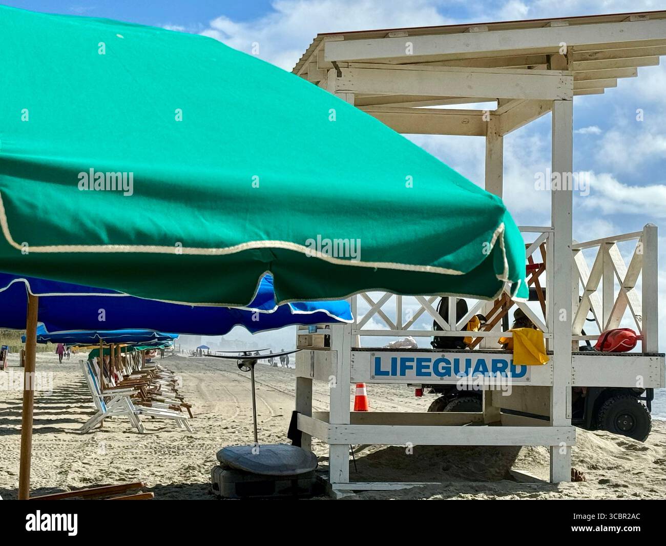 Beach umbrellas lined up behind a lifeguard station at Myrtle Beach - Smartphone Captured Stock Image
