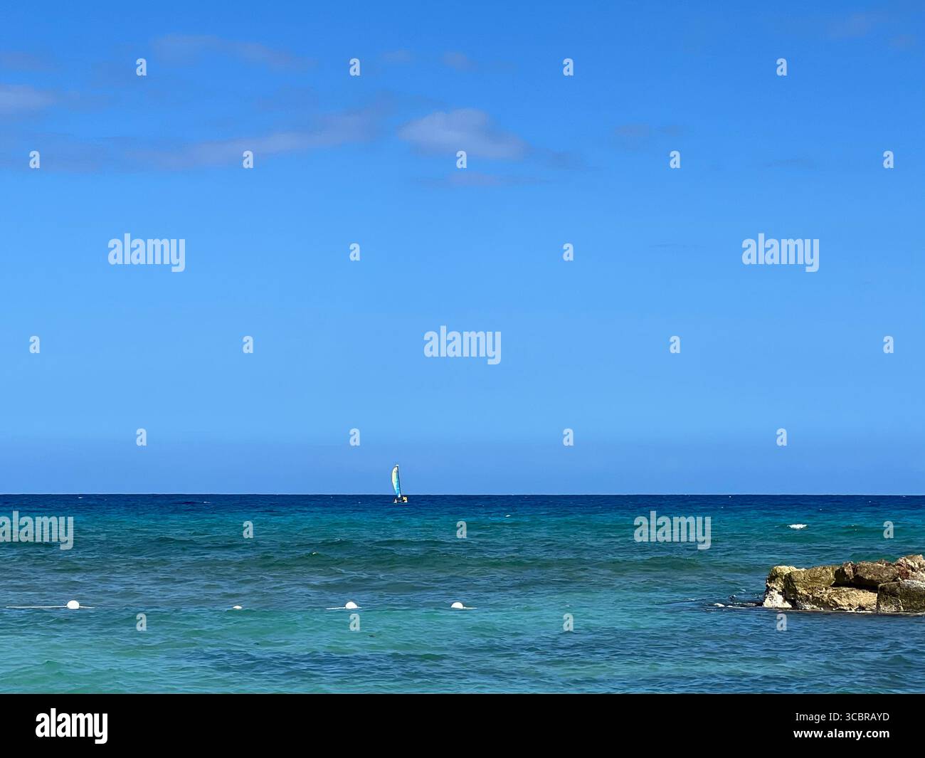 A lone sailboard in the Caribbean - Smartphone Captured Stock Image
