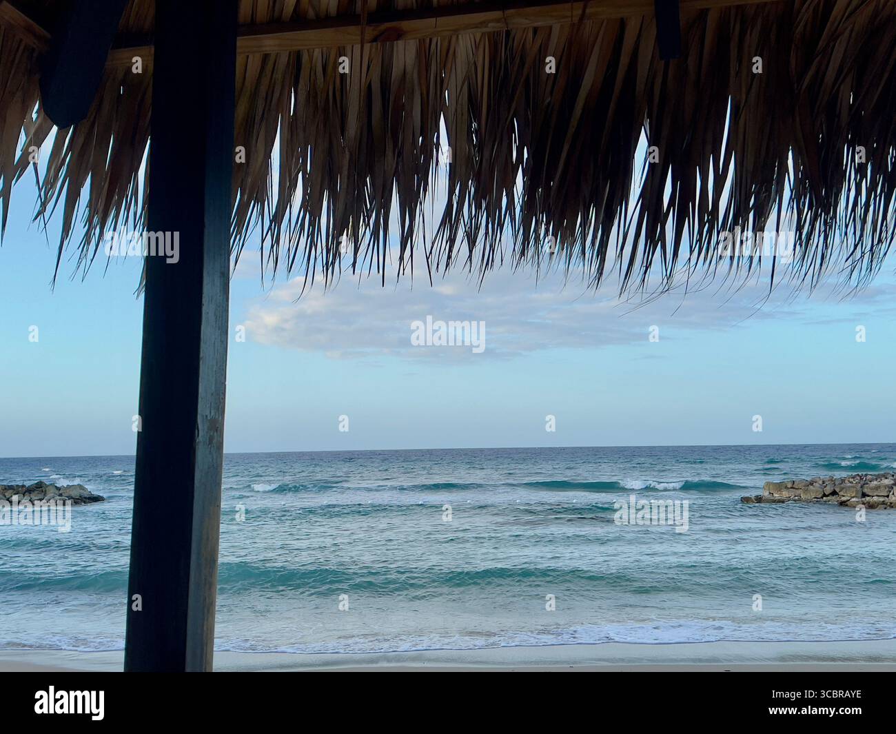 View from inside a beach cabana looking out to the Caribbean Sea, Montego Bay, Jamaica - Smartphone Captured Stock Image