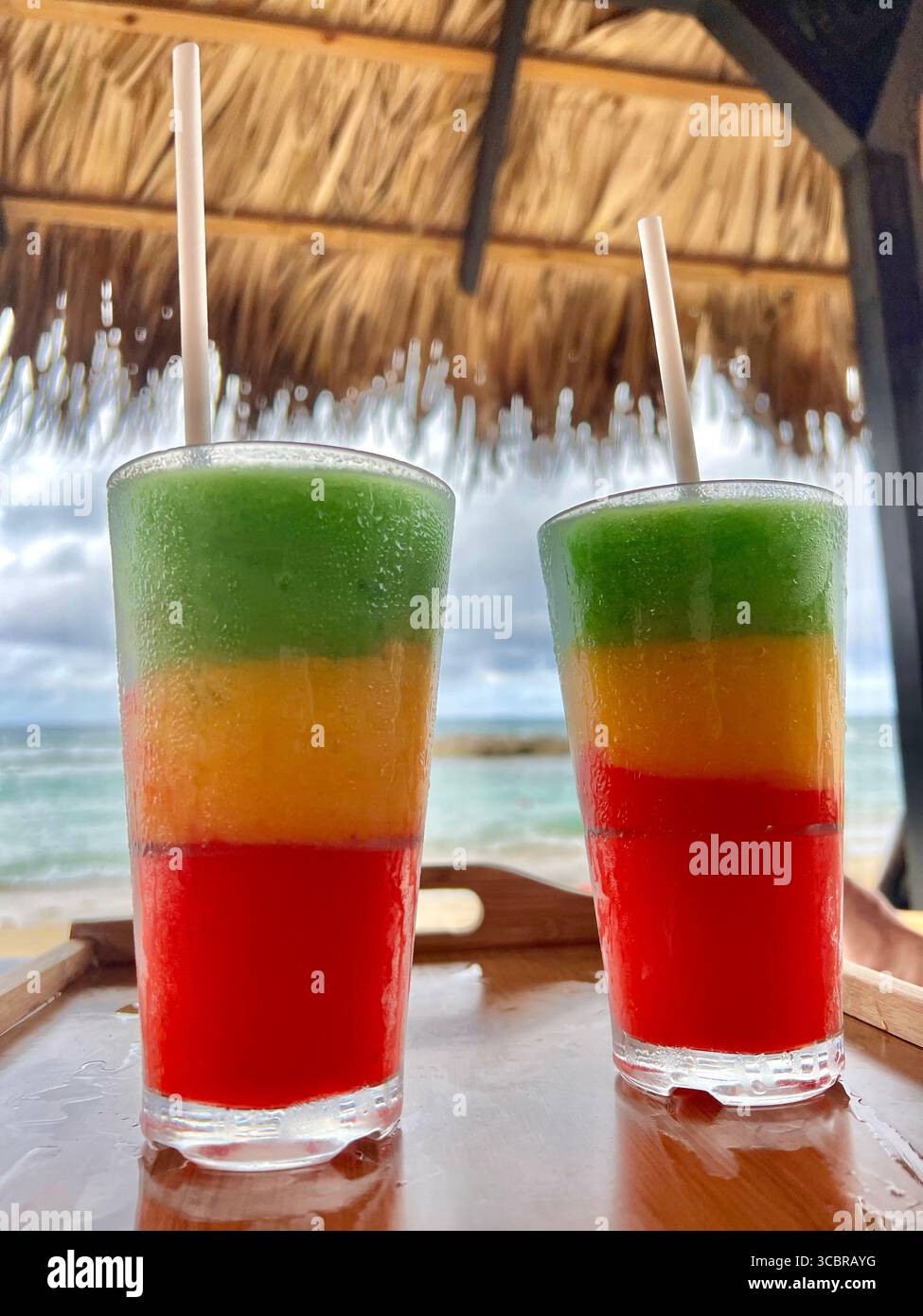 A pair of Bob Marley frozen cocktails enjoyed in thatched cabana in Montego Bay, Jamaica, - Smartphone Captured Stock Image