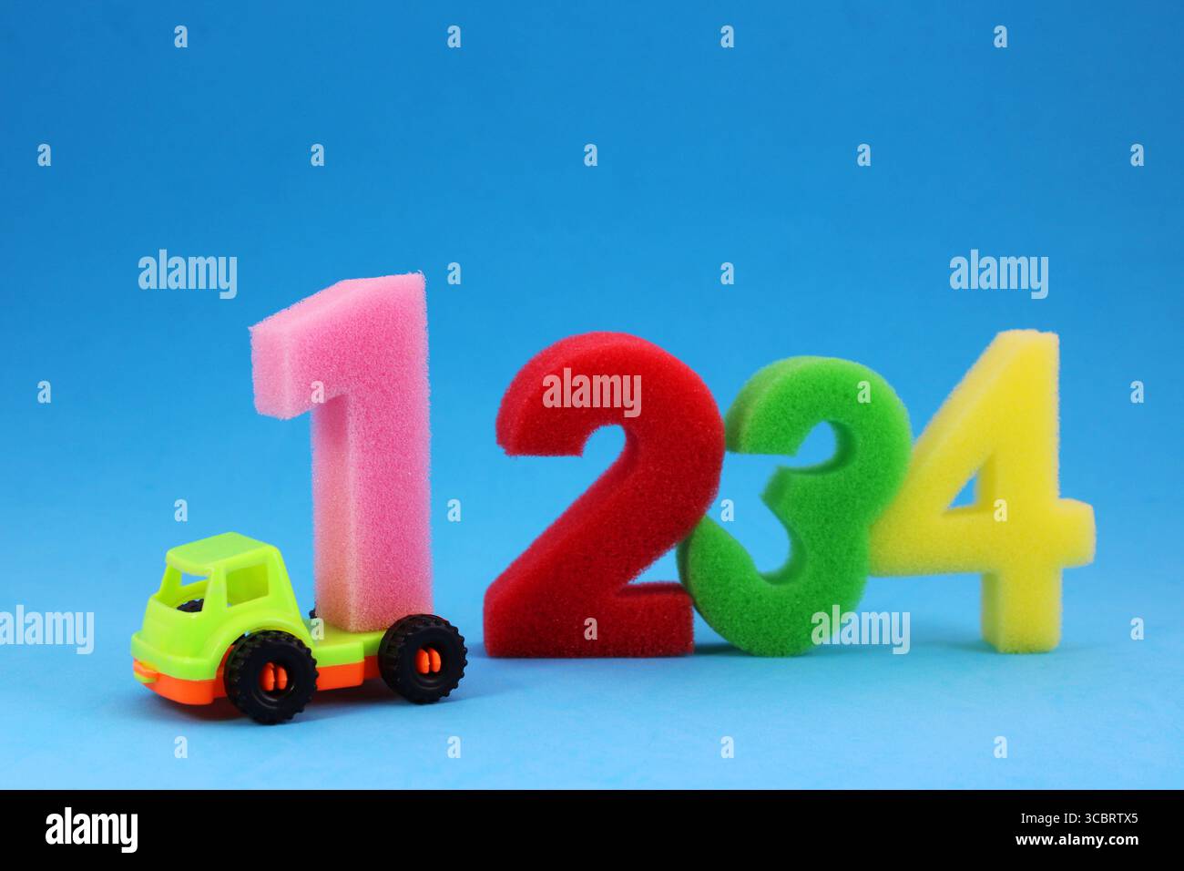 Truck delivering number one, colorful sponge numbers Stock Photo - Alamy