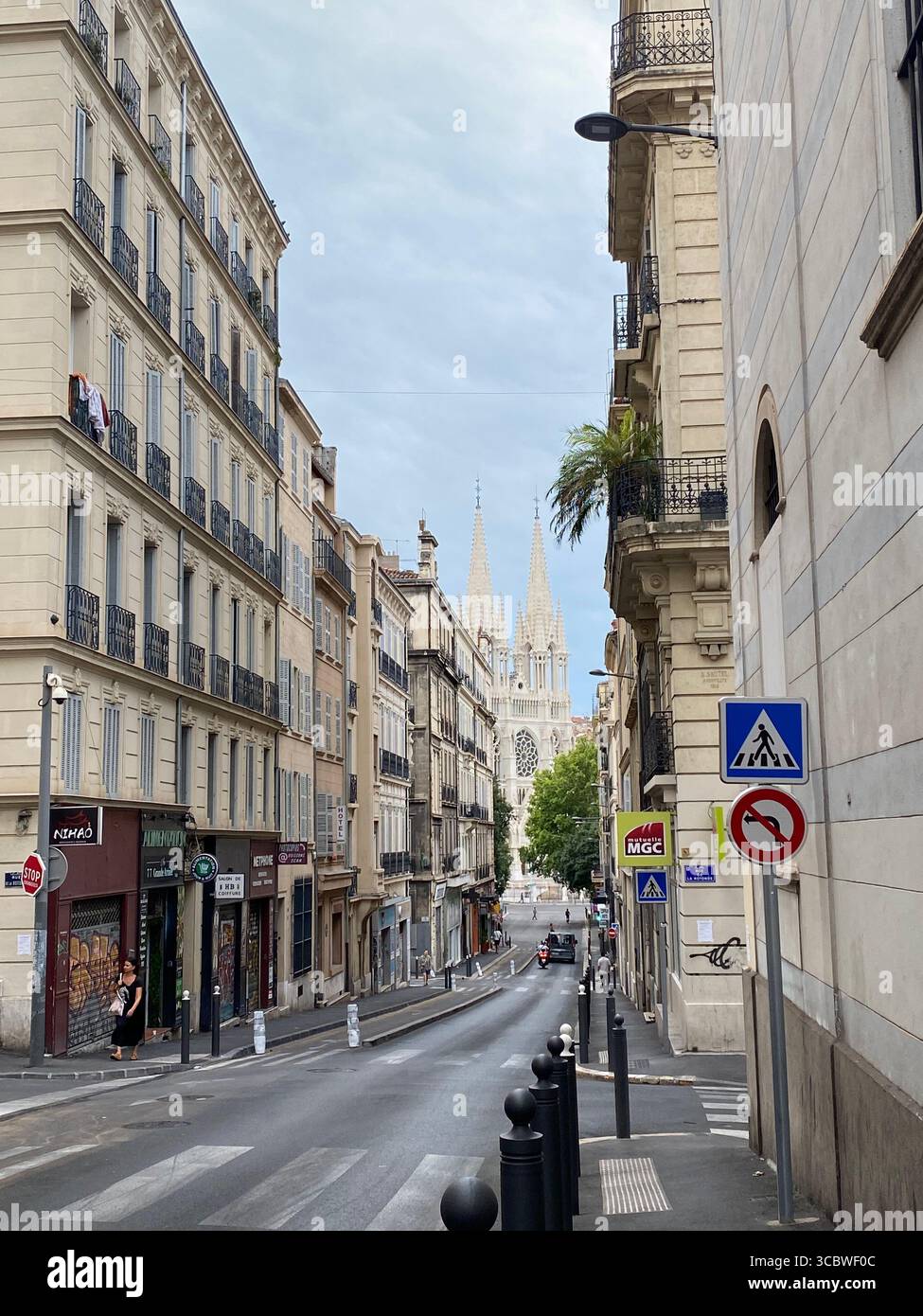 a peek a boo view of a church in a narrow street in marseille on an early, fresh summer morning - Smartphone Captured Stock Image