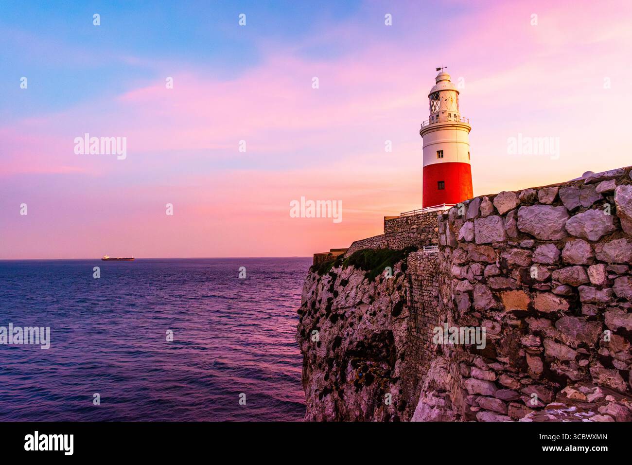 The lighthous in Gibraltar at sunset on a rock by the shores of the Mediterranean Sea Stock Photo