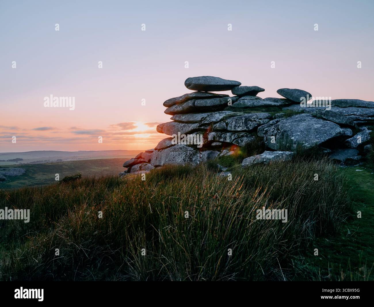 Sunset over the granite tor on Stowes Hill, Minions, Bodmin Moor, Cornwall England UK Stock Photo