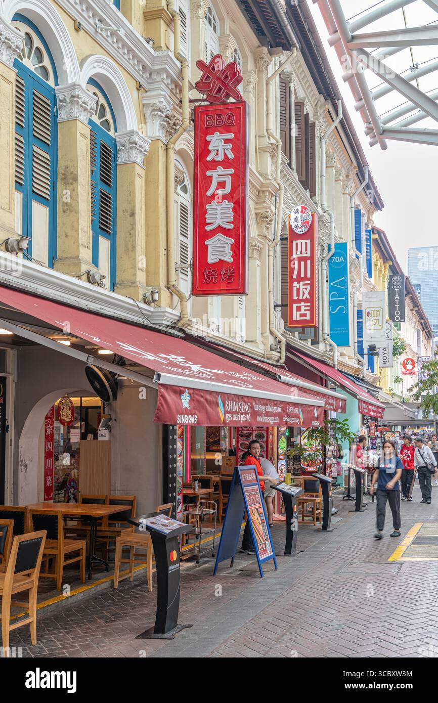 Street Scene in Chinatown with modern skyscrapers in the distance, Singapore Stock Photo