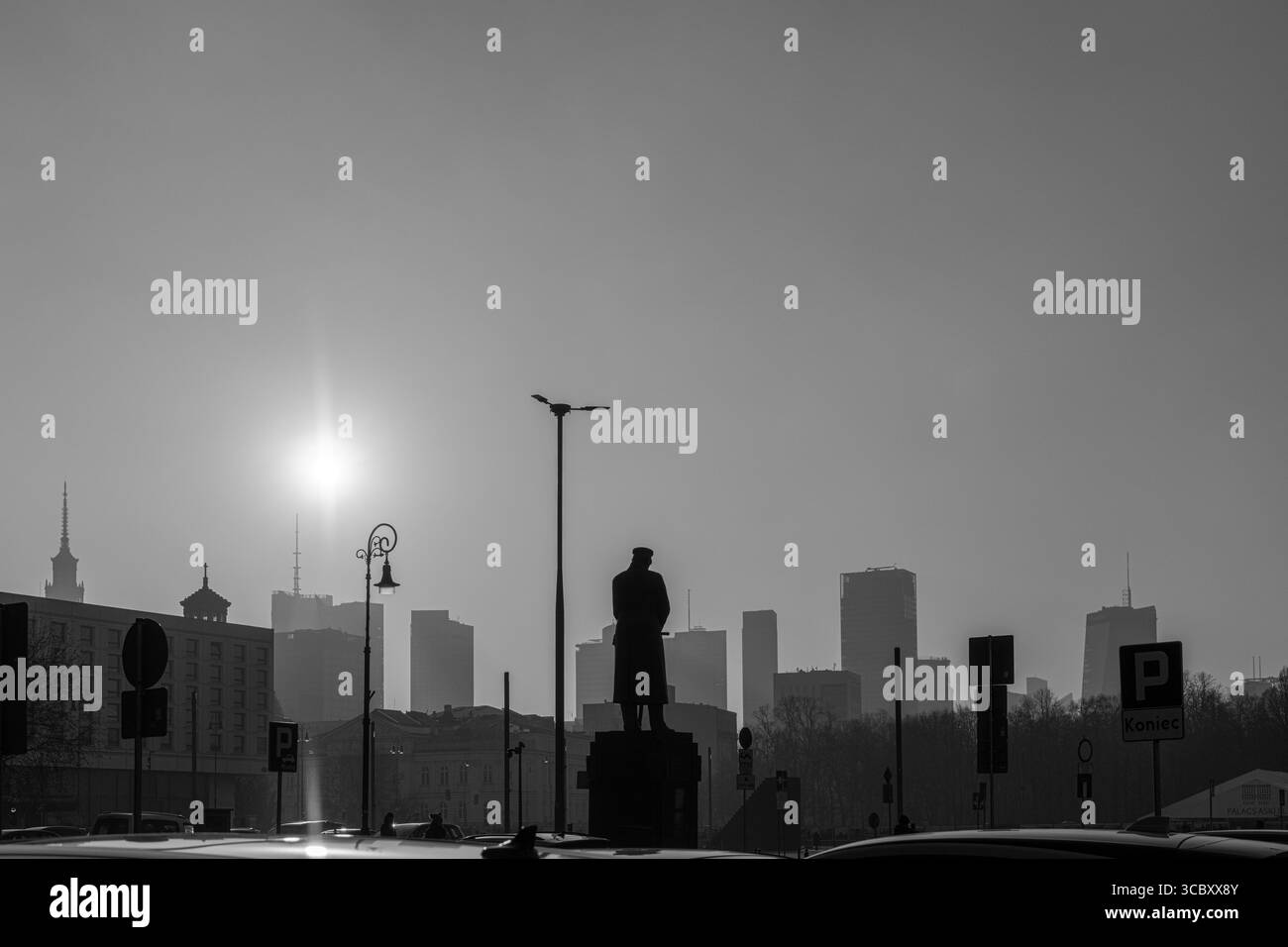 the winter sun setting over Warsaw's skyline with the statue of General Józef Piłsudski watching on Stock Photo