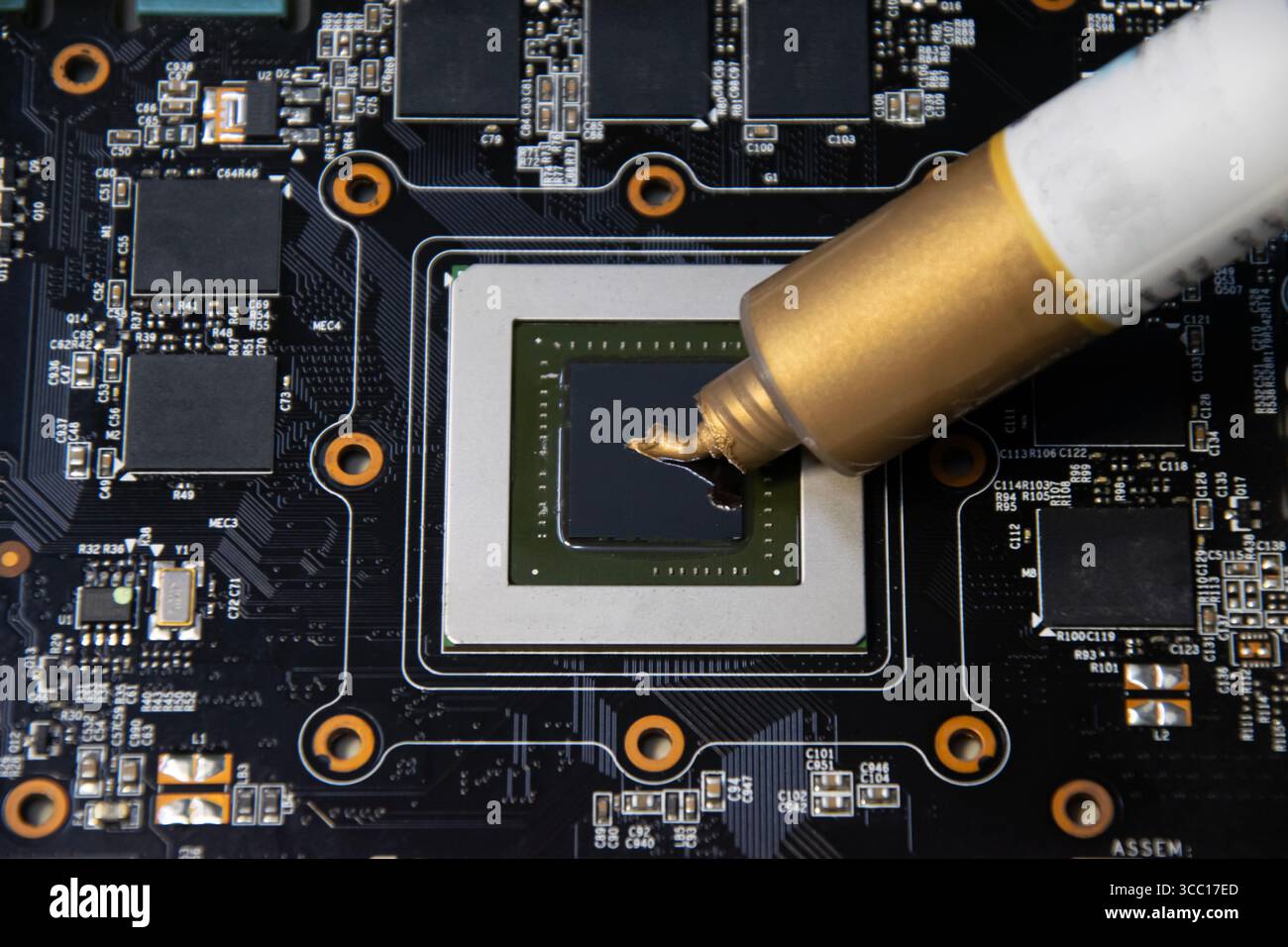 The image shows the application of thermal silicone to the CPU chip ...